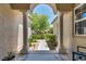 View of front yard between exterior columns, desert landscaping, and walkway to 2-car garage at 6423 Grayback Dr, North Las Vegas, NV 89084