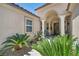 Inviting front entrance with decorative columns and desert landscaping for enhanced curb appeal at 6423 Grayback Dr, North Las Vegas, NV 89084