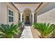 Warm and welcoming front entrance with elegant columns and well-maintained desert landscaping at 6423 Grayback Dr, North Las Vegas, NV 89084