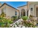 Charming home entrance with desert landscaping and a walkway leading to the front door at 6423 Grayback Dr, North Las Vegas, NV 89084