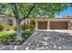 Inviting home showcasing a two-car garage and well-maintained front yard with mature landscaping at 6423 Grayback Dr, North Las Vegas, NV 89084
