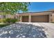 Attractive home featuring a two-car garage, desert landscaping, and a well-maintained lawn at 6423 Grayback Dr, North Las Vegas, NV 89084