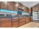 Gourmet kitchen with granite counters, wood cabinets, and stainless steel appliances at 6423 Grayback Dr, North Las Vegas, NV 89084