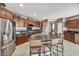 Spacious kitchen with stainless steel appliances, granite counters, a large island, and barstool seating at 6423 Grayback Dr, North Las Vegas, NV 89084