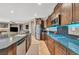 Open kitchen with island, granite counters, stainless steel appliances, and breakfast bar at 6423 Grayback Dr, North Las Vegas, NV 89084
