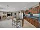 Open kitchen with granite countertops, an island with seating and sleek appliances at 6423 Grayback Dr, North Las Vegas, NV 89084