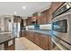 Modern kitchen featuring stainless steel appliances, granite counters, and a breakfast bar at 6423 Grayback Dr, North Las Vegas, NV 89084