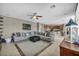 Inviting living room with a sectional sofa, tile floors, and a view into the kitchen at 6423 Grayback Dr, North Las Vegas, NV 89084