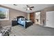 Spacious main bedroom featuring neutral tones, shutters, and a sliding barn door to ensuite at 6423 Grayback Dr, North Las Vegas, NV 89084