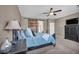 Comfortable main bedroom with a ceiling fan, warm tones, and ample natural light at 6423 Grayback Dr, North Las Vegas, NV 89084