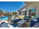 Inviting outdoor patio area with modern furniture and a sparkling pool, perfect for relaxation and entertaining at 6423 Grayback Dr, North Las Vegas, NV 89084
