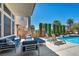 Beautifully designed patio with lounge chairs, a cozy seating area, and access to a refreshing swimming pool at 6423 Grayback Dr, North Las Vegas, NV 89084