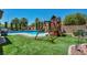 Backyard playground area featuring a playhouse and artificial turf at 6423 Grayback Dr, North Las Vegas, NV 89084