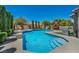A luxurious backyard pool with a spa, a playground, and a barbecue area at 6423 Grayback Dr, North Las Vegas, NV 89084
