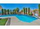 Luxurious pool area with lush landscaping and outdoor seating at 6423 Grayback Dr, North Las Vegas, NV 89084