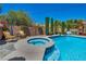 Backyard featuring a sparkling pool, spa, and an outdoor lounge area at 6423 Grayback Dr, North Las Vegas, NV 89084