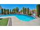 Backyard pool and spa with lush landscaping and lounge chairs at 6423 Grayback Dr, North Las Vegas, NV 89084