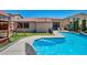 An inviting backyard pool with artificial grass and a play structure at 6423 Grayback Dr, North Las Vegas, NV 89084
