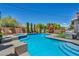 Outdoor pool area featuring a spa, grill, and manicured privacy landscaping at 6423 Grayback Dr, North Las Vegas, NV 89084