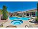 A sparkling backyard oasis features a pool, spa, and lounge area at 6423 Grayback Dr, North Las Vegas, NV 89084