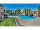 Inviting backyard pool with lush landscaping and outdoor grill at 6423 Grayback Dr, North Las Vegas, NV 89084