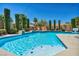 Sparkling pool with a spa, surrounded by lush landscaping at 6423 Grayback Dr, North Las Vegas, NV 89084