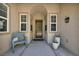 Cozy front porch featuring a charming bench, potted plants, and a welcoming entryway at 6423 Grayback Dr, North Las Vegas, NV 89084