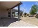 Inviting covered patio and landscaped yard with stone accents in a private backyard at 7072 Arabian Ridge St, Las Vegas, NV 89131