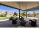 Charming backyard patio with a cozy seating area and a modern fire pit at 7072 Arabian Ridge St, Las Vegas, NV 89131