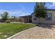 Lush green backyard with mature tree and outdoor patio for relaxing and entertaining at 7072 Arabian Ridge St, Las Vegas, NV 89131