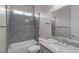 Well-lit bathroom featuring a tub with stone-like finish and a single sink vanity at 7072 Arabian Ridge St, Las Vegas, NV 89131