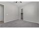 Neutral bedroom features plush carpeting and a ceiling fan at 7072 Arabian Ridge St, Las Vegas, NV 89131
