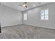 Spacious bedroom featuring plush carpeting, neutral walls, a ceiling fan, and window shutters at 7072 Arabian Ridge St, Las Vegas, NV 89131