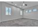 Neutral bedroom with three windows and a ceiling fan with a carpeted floor at 7072 Arabian Ridge St, Las Vegas, NV 89131