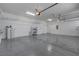 Spacious garage with overhead storage racks, bright lighting, and epoxy flooring at 7072 Arabian Ridge St, Las Vegas, NV 89131