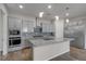 Well-equipped kitchen with granite counters, stainless appliances, and pendant lights over a central island at 7072 Arabian Ridge St, Las Vegas, NV 89131