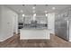 Modern kitchen boasting a large island, stainless steel appliances, and stylish pendant lighting at 7072 Arabian Ridge St, Las Vegas, NV 89131
