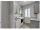 Well-lit laundry room with modern washer, dryer and storage at 7072 Arabian Ridge St, Las Vegas, NV 89131