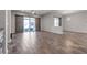 Spacious living room with wood-look tile, recessed lighting, and sliding glass doors to the backyard at 7072 Arabian Ridge St, Las Vegas, NV 89131