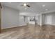 Open-concept living space featuring wood-look tile, recessed lighting, and seamlessly connected to the kitchen at 7072 Arabian Ridge St, Las Vegas, NV 89131