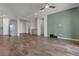 Modern living space with wood-look tile floors, neutral walls, and an accent wall with media connections at 7072 Arabian Ridge St, Las Vegas, NV 89131