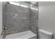 Shower and bath combination with marble surround and brushed nickel hardware at 7072 Arabian Ridge St, Las Vegas, NV 89131