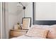 Close up of the modern nightstand in the bedroom with flowers, lamp and framed art at 7350 N Decatur Blvd # 5, Las Vegas, NV 89131