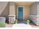 Charming front entrance featuring a teal door, stone accents, and decorative plants at 7350 N Decatur Blvd # 5, Las Vegas, NV 89131