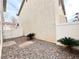 Backyard with rock landscaping, white fence, and some small plants at 7371 Catmint St, Las Vegas, NV 89113