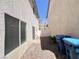 View of a small backyard with rock landscaping and two waste bins at 7371 Catmint St, Las Vegas, NV 89113