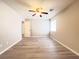 Spacious bedroom with wood-look floors, ceiling fan and a window at 7371 Catmint St, Las Vegas, NV 89113
