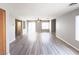 Large living room with modern hard surface floors and views to a private outdoor patio at 7371 Catmint St, Las Vegas, NV 89113