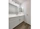 Bathroom vanity with drawers, large mirror, modern lights, and luxury vinyl plank flooring at 7900 Wood Shadow Ct, Las Vegas, NV 89131