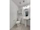 Half-bath with tiled floor, pedestal sink, and modern light fixture at 7900 Wood Shadow Ct, Las Vegas, NV 89131